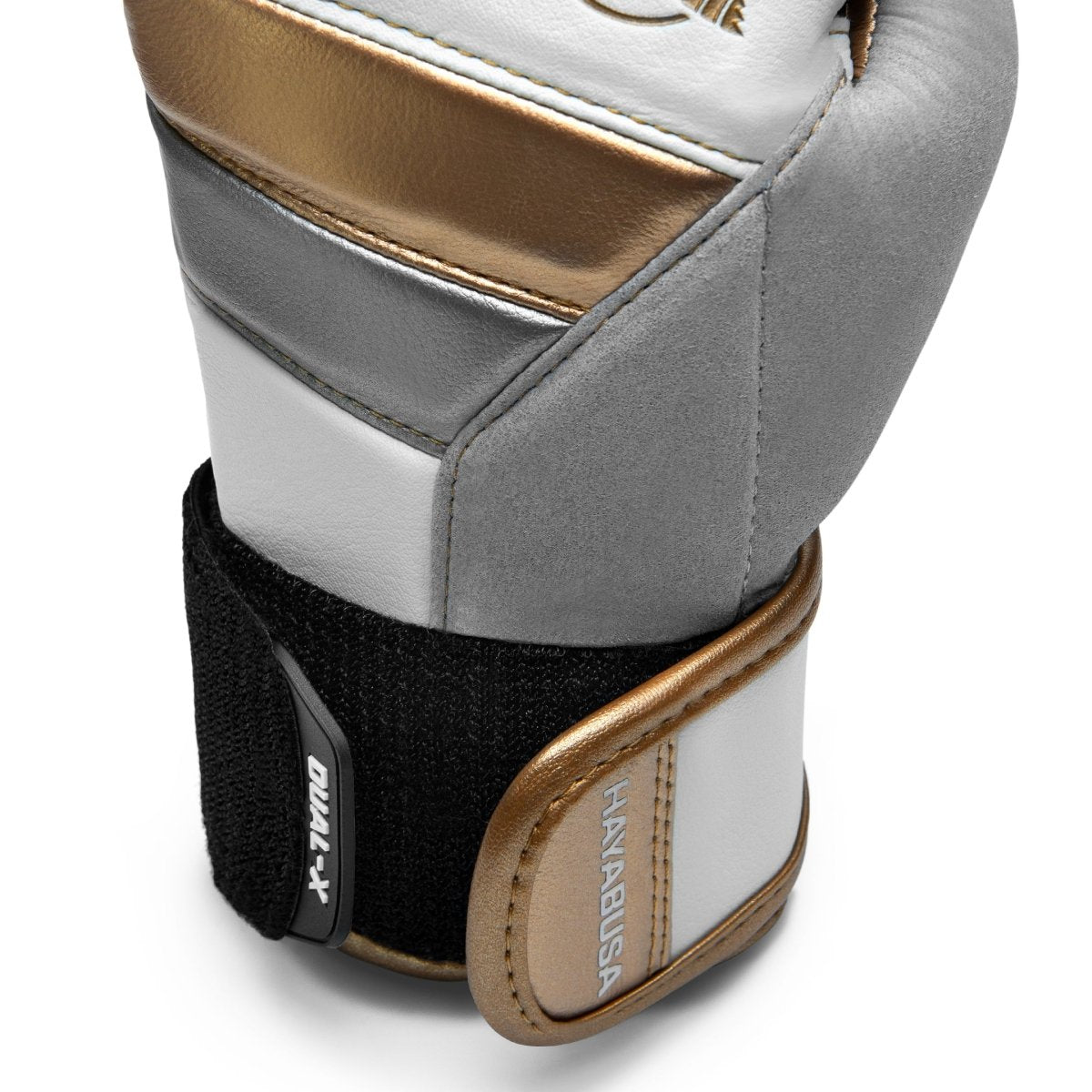 Close-up van de versterkte sluiting van de wit/gouden Hayabusa T3-handschoenen
