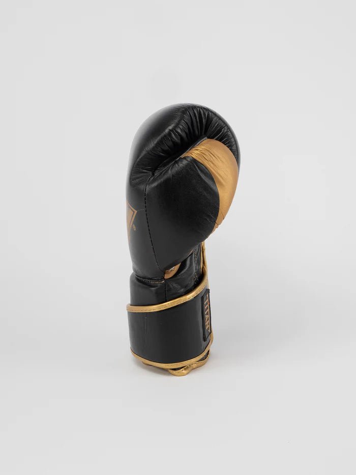 Vedere laterală a mănușii Titan Boxing Metal auriu negru, detaliu de sprijin pentru degetul mare