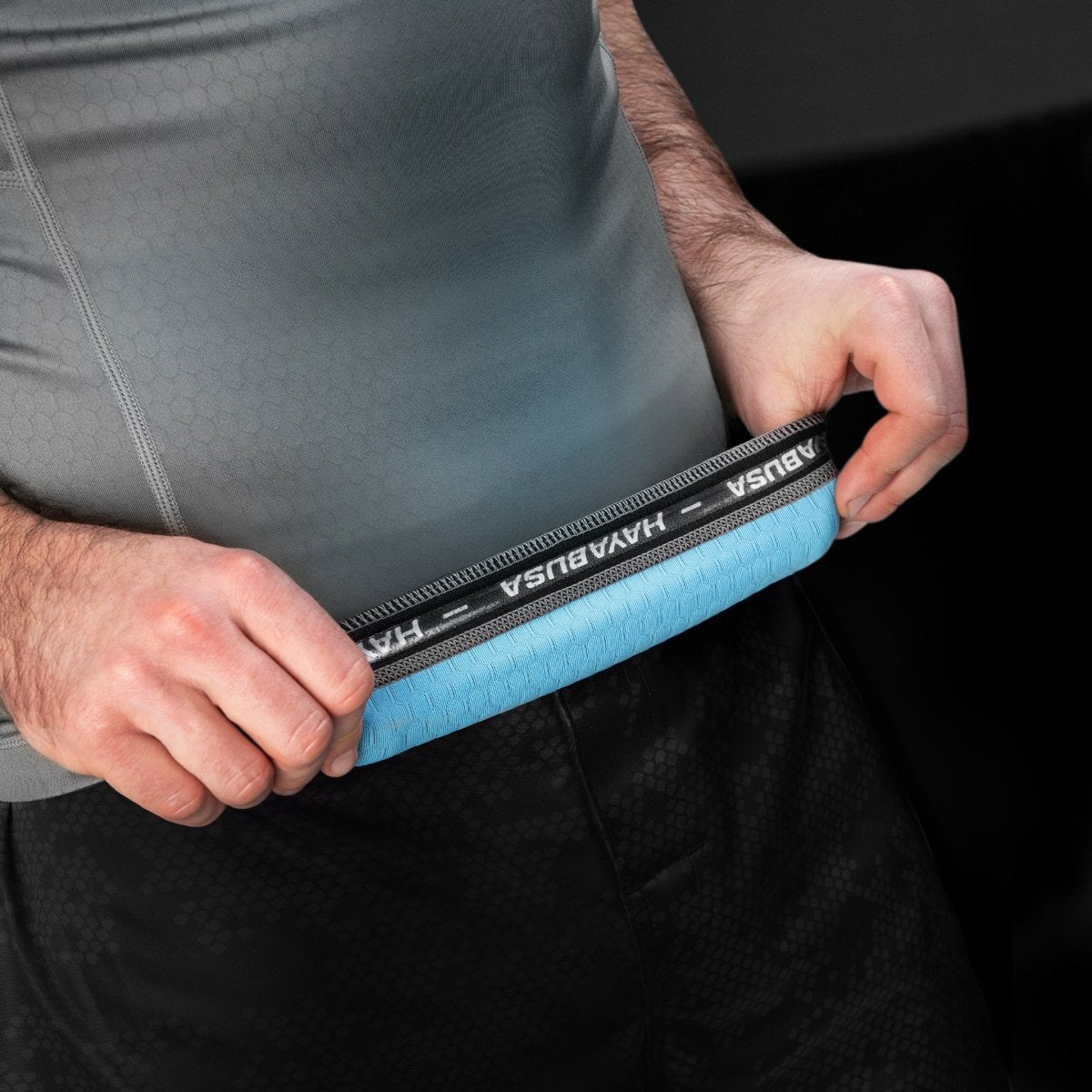 Intern detail van de siliconen tailleband van de grijs/lichtblauwe Hayabusa Fusion rashguard voor een nauwsluitende pasvorm