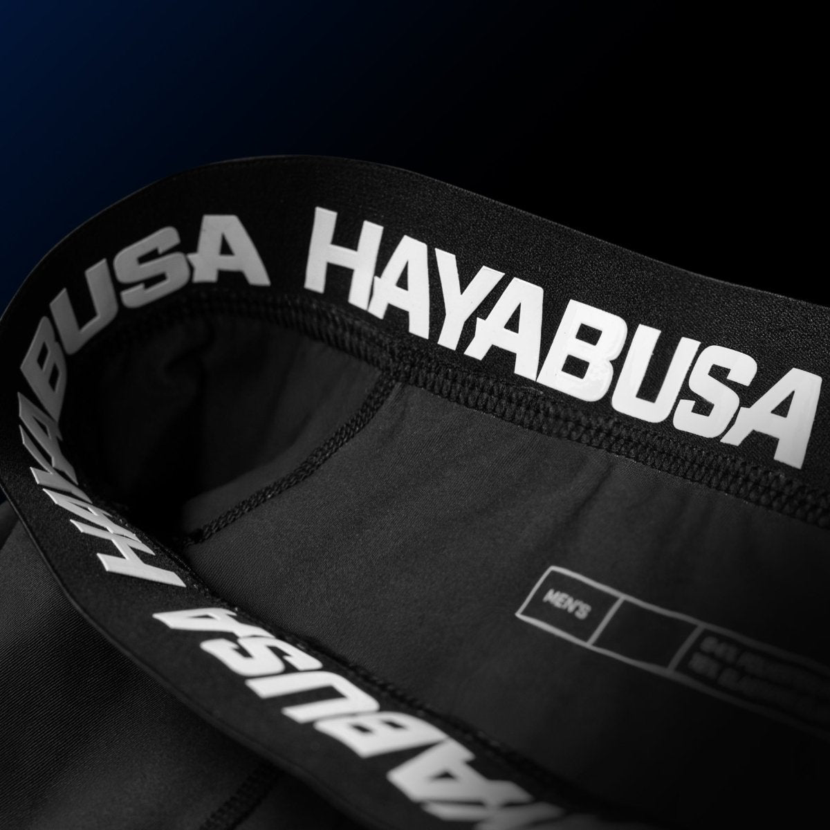 Detail van de sluiting en interne siliconenvoering van de blauwe UFC BJJ-short